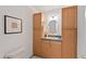 Bathroom features wood cabinets, decorative mirror and a blue countertop at 307 Country Club Dr, Durham, NC 27712