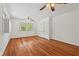 Empty bedroom with hardwood floors, a ceiling fan, and a bank of closets at 307 Country Club Dr, Durham, NC 27712