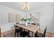 Bright dining room features modern light fixture, wood table, and white walls at 307 Country Club Dr, Durham, NC 27712