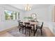 Bright dining room features modern light fixture, wood table, and large window at 307 Country Club Dr, Durham, NC 27712