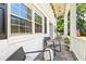 Inviting front porch with slate flooring, comfortable seating, and classic white railings at 307 Country Club Dr, Durham, NC 27712