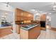 Spacious kitchen with cooktop island, hardwood cabinets and a view of the dining room at 307 Country Club Dr, Durham, NC 27712
