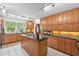 Bright kitchen boasts an island cooktop, ample cabinets, and views of the well-manicured front yard at 307 Country Club Dr, Durham, NC 27712