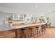Eat-in kitchen featuring hardwood floors, white cabinetry, and a butcher block countertop with seating at 307 Country Club Dr, Durham, NC 27712
