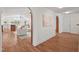 Open-concept living space with hardwood floors, large windows, and seamless flow to other areas at 307 Country Club Dr, Durham, NC 27712