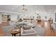 Expansive living room with hardwood floors, vaulted ceiling, and a modern seating arrangement at 307 Country Club Dr, Durham, NC 27712