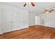 Bright main bedroom features hardwood floors, ceiling fan, and large closet at 307 Country Club Dr, Durham, NC 27712