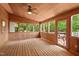 Bright sunroom with wood floors, walls, and many windows, creating an inviting indoor-outdoor space at 307 Country Club Dr, Durham, NC 27712