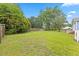 Expansive backyard with lush green grass, mature trees, and a wooden fence, providing ample space at 314 Lane Rd, Dunn, NC 28334