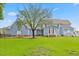 Spacious backyard with a patio, manicured lawn, and mature trees, perfect for entertaining at 314 Lane Rd, Dunn, NC 28334