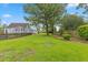 Expansive backyard featuring a well-maintained lawn and mature trees, offering ample space for outdoor activities at 314 Lane Rd, Dunn, NC 28334