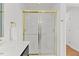 Bright bathroom featuring a glass-enclosed shower, sink with black cabinet, and neutral wall color at 314 Lane Rd, Dunn, NC 28334