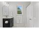 Bathroom with a single sink vanity, decorative mirror, and shower with a white curtain at 314 Lane Rd, Dunn, NC 28334