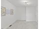 A well-lit room with neutral carpet, white walls, modern lighting, and tasteful floral artwork at 314 Lane Rd, Dunn, NC 28334