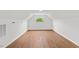 Large bonus room with a wood floor and an arched window offering natural light with the fresh white paint at 314 Lane Rd, Dunn, NC 28334