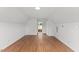 Large bonus room with a wood floor and a doorway leading to the other rooms in the house with fresh white paint at 314 Lane Rd, Dunn, NC 28334