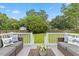 Relaxing back deck with comfortable seating, offering serene views of the backyard and surrounding trees at 314 Lane Rd, Dunn, NC 28334