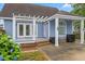 Charming home exterior featuring a pergola, arched window, and well-maintained landscaping at 314 Lane Rd, Dunn, NC 28334