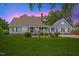 Charming two-story home featuring a well-manicured lawn, inviting front porch, and classic architectural details at 314 Lane Rd, Dunn, NC 28334