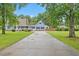 Inviting two-story home with a spacious driveway, well-kept lawn, and classic architectural details at 314 Lane Rd, Dunn, NC 28334