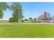 Spacious front yard featuring a well-manicured lawn and a charming view of the two-story home at 314 Lane Rd, Dunn, NC 28334