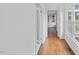 Inviting hallway with wood floors, white walls, and windows showcasing the outdoor view at 314 Lane Rd, Dunn, NC 28334