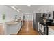 Kitchen with granite countertops, stainless steel appliances, white cabinets and hardwood floors throughout at 314 Lane Rd, Dunn, NC 28334