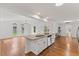 Bright, open kitchen with granite island, white cabinets, hardwood floors, and an adjacent living area at 314 Lane Rd, Dunn, NC 28334