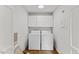 Convenient laundry room with a washer, dryer, and storage space above at 314 Lane Rd, Dunn, NC 28334