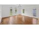 Spacious living room with hardwood floors, white walls, and view of the fenced backyard through French doors at 314 Lane Rd, Dunn, NC 28334