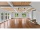 Large living room with hardwood floors, neutral decor, and natural light from windows and French doors at 314 Lane Rd, Dunn, NC 28334