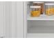 Pantry with white walls and shelves stocked with various food items at 314 Lane Rd, Dunn, NC 28334