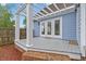 Inviting porch with pergola, brick accents, and access through elegant double doors at 314 Lane Rd, Dunn, NC 28334