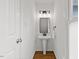 Small powder room showcasing a pedestal sink and modern lighting fixture at 314 Lane Rd, Dunn, NC 28334