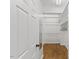 Well-organized walk-in closet with rods, shelving, mirror and wood flooring for ample storage space at 314 Lane Rd, Dunn, NC 28334