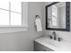 Powder room with modern vanity, mirror, and fixtures at 321 Commons Walk Cir, Cary, NC 27519