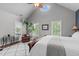 Bright bedroom with vaulted ceiling, oval window, plantation shutters, and a large potted plant at 321 Commons Walk Cir, Cary, NC 27519
