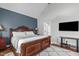 The bedroom has hardwood floors, a stunning bed and connects to the bathroom at 321 Commons Walk Cir, Cary, NC 27519