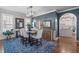 Stylish dining room with elegant chairs, wood table, blue accent wall, and hardwood floors at 321 Commons Walk Cir, Cary, NC 27519