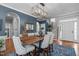 Chic dining room with a rustic table, upholstered chairs, and elegant decor touches at 321 Commons Walk Cir, Cary, NC 27519