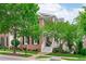 Attractive brick home with a cozy front porch, surrounded by beautiful trees at 321 Commons Walk Cir, Cary, NC 27519