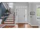 Elegant foyer with hardwood floors, staircase, and natural light, creating a welcoming entrance at 321 Commons Walk Cir, Cary, NC 27519