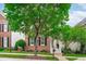 Inviting brick home with neat landscaping, black shutters, and a cozy front porch with steps at 321 Commons Walk Cir, Cary, NC 27519