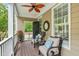 Charming front porch with comfortable chairs, ceiling fan, and stylish decor at 321 Commons Walk Cir, Cary, NC 27519