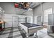 Finished garage space with a pool table, storage cabinets and epoxy floors at 321 Commons Walk Cir, Cary, NC 27519
