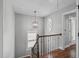 Hallway features hardwood floors, staircase, windows, and a caged light fixture at 321 Commons Walk Cir, Cary, NC 27519