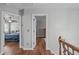 Upstairs hallway featuring hardwood floors and access to bedrooms at 321 Commons Walk Cir, Cary, NC 27519