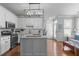 Modern kitchen features white cabinets, stainless steel appliances, and a center island at 321 Commons Walk Cir, Cary, NC 27519