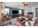Living room area with hardwood floors, ceiling fan, TV, sofa and natural light at 321 Commons Walk Cir, Cary, NC 27519