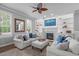 Bright living room features custom built-ins, a fireplace, stylish furniture and decor at 321 Commons Walk Cir, Cary, NC 27519